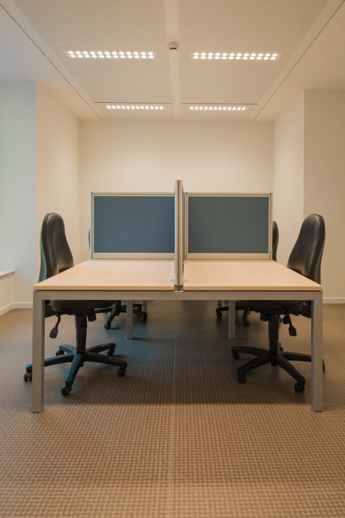 white cubicle with rolling chairs
